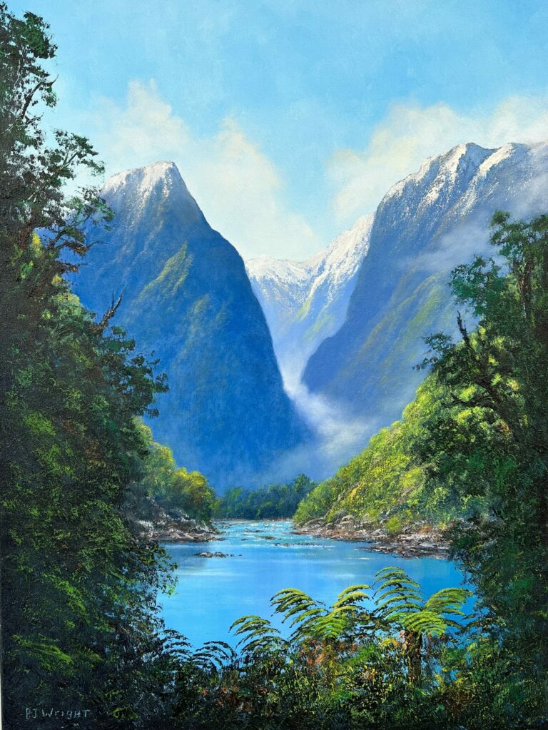 The Milford Track offers a serene landscape, featuring a clear blue river meandering through a valley adorned with lush green trees and framed by majestic snow-capped mountains, all beneath a bright blue sky.